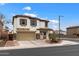 Charming two-story home featuring a two-car garage and landscaped yard under a beautiful blue sky at 18222 W Lundberg St, Surprise, AZ 85388
