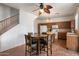 Eat-in kitchen with wooden cabinets, an island and a dining table, providing a functional space for everyday meals at 18222 W Lundberg St, Surprise, AZ 85388