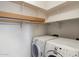 Functional laundry room with shelving above the side-by-side washer and dryer at 18222 W Lundberg St, Surprise, AZ 85388