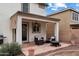 Relaxing covered patio with comfortable seating, a ceiling fan, and a fire pit at 18222 W Lundberg St, Surprise, AZ 85388