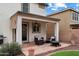 Relaxing covered patio with comfortable seating, a ceiling fan, and a fire pit at 18222 W Lundberg St, Surprise, AZ 85388