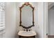 Chic powder room showcasing a decorative mirror and a marble-topped vanity at 18222 W Lundberg St, Surprise, AZ 85388