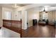 Spacious upstairs landing with a view into a cozy sitting area and a view of a wooden staircase at 18222 W Lundberg St, Surprise, AZ 85388