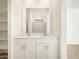 Modern bathroom with a double sink vanity, white cabinetry, and a large mirror at 19390 N Fiano Dr, Maricopa, AZ 85138
