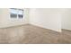 Bright, empty bedroom with tile flooring and a large window offering ample natural light at 19390 N Fiano Dr, Maricopa, AZ 85138