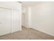 Cozy bedroom with sliding closet doors and neutral carpeting at 19390 N Fiano Dr, Maricopa, AZ 85138