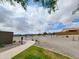 Landscaped common area with sidewalk, native trees, drought tolerant landscaping, and views of homes at 19390 N Fiano Dr, Maricopa, AZ 85138