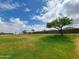 Neighborhood park with green grass, a playground, and drought-resistant landscaping at 19390 N Fiano Dr, Maricopa, AZ 85138
