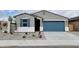 Charming single-story home with blue garage door, blue shutters and low maintenance landscaping at 19390 N Fiano Dr, Maricopa, AZ 85138