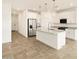 Modern kitchen featuring granite countertops, stainless steel appliances, and an island with pendant lighting at 19390 N Fiano Dr, Maricopa, AZ 85138