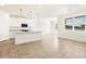 Open-concept kitchen with granite island, stainless steel appliances, pendant lights, and abundant natural light at 19390 N Fiano Dr, Maricopa, AZ 85138