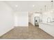Open-concept living space featuring elegant tile floors, connecting seamlessly with the kitchen area at 19390 N Fiano Dr, Maricopa, AZ 85138