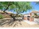 Outdoor kitchen features a grill, countertop space, and a relaxing pergola, ideal for entertaining in the backyard at 19607 N Flint Way, Surprise, AZ 85374
