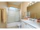 Clean bathroom with a single sink vanity, updated fixtures, walk in shower, and neutral color palette at 19607 N Flint Way, Surprise, AZ 85374
