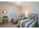 Cozy bedroom with twin beds, ceiling fan, natural light, and a comfortable atmosphere for restful nights at 19607 N Flint Way, Surprise, AZ 85374