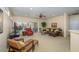 Open-concept living room with a ceiling fan, a comfortable leather sectional, and views of the backyard at 19607 N Flint Way, Surprise, AZ 85374
