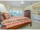 Inviting main bedroom with a large window, ceiling fan, ensuite bathroom, and ample space for relaxation at 19607 N Flint Way, Surprise, AZ 85374