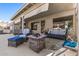 Inviting covered patio with a stone fire pit and comfortable seating area at 19930 N 98Th Ave, Peoria, AZ 85382