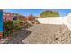 Expansive backyard area with decorative rock, mature trees, and privacy fencing at 19930 N 98Th Ave, Peoria, AZ 85382