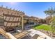 Spacious backyard with a covered hot tub, outdoor seating, manicured lawn and mature landscaping at 19930 N 98Th Ave, Peoria, AZ 85382