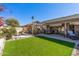 Lush backyard featuring a well-manicured lawn, pergola, and serene seating area at 19930 N 98Th Ave, Peoria, AZ 85382