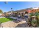 Backyard boasts covered and uncovered outdoor living spaces, hot tub, mature plantings and rock landscaping at 19930 N 98Th Ave, Peoria, AZ 85382