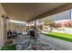Relaxing covered patio featuring comfortable seating, privacy screens, and serene garden views at 19930 N 98Th Ave, Peoria, AZ 85382