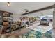 Spacious garage filled with various items, open door showing driveway and car at 19930 N 98Th Ave, Peoria, AZ 85382