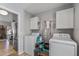 Efficient laundry room with modern washer and dryer and convenient storage cabinets at 19930 N 98Th Ave, Peoria, AZ 85382