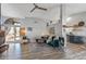 Bright living room featuring wood-look floors, vaulted ceiling, and an open floor plan at 19930 N 98Th Ave, Peoria, AZ 85382