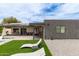 The backyard offers an outdoor seating area, inground pool, manicured lawn, and low maintenance landscaping at 2033 E Janice Way, Phoenix, AZ 85022