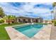 The spacious backyard features a pool, outdoor dining, lounge chairs, and desert landscaping at 2033 E Janice Way, Phoenix, AZ 85022