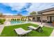 This backyard has an inground pool, manicured lawn, desert landscaping, and lounge chairs at 2033 E Janice Way, Phoenix, AZ 85022