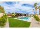 This house has a backyard pool and spa with outdoor dining and seating areas and lush landscaping at 2033 E Janice Way, Phoenix, AZ 85022