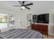 A modern bedroom offering backyard access, a large television, and well-placed laundry appliances at 2033 E Janice Way, Phoenix, AZ 85022