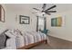 Calm bedroom with a striped comforter, window, and a desk, offering a cozy retreat at 2033 E Janice Way, Phoenix, AZ 85022