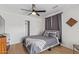 A serene bedroom with hardwood floors, a ceiling fan, and a closet featuring sliding doors at 2033 E Janice Way, Phoenix, AZ 85022
