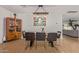 Open-concept dining area featuring modern decor, stylish light fixture, and wood laminate flooring at 2033 E Janice Way, Phoenix, AZ 85022