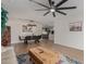 Open-concept living and dining area featuring modern decor, stylish light fixture, and wood laminate flooring at 2033 E Janice Way, Phoenix, AZ 85022