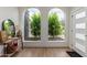 Bright entryway featuring hardwood floors, and view of drought tolerant front yard landscaping through large arched windows at 2033 E Janice Way, Phoenix, AZ 85022
