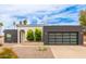 Charming single-story home featuring unique architectural details and desert landscaping, a modern garage door and drought tolerant plantings at 2033 E Janice Way, Phoenix, AZ 85022