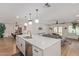 Open concept kitchen with a large island and a seamless transition to the dining and living areas at 2033 E Janice Way, Phoenix, AZ 85022