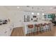 Well-lit kitchen boasting white cabinetry, a spacious island, and modern pendant lighting at 2033 E Janice Way, Phoenix, AZ 85022