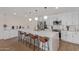 Bright kitchen featuring white cabinets, stainless steel appliances, and a large island with bar seating at 2033 E Janice Way, Phoenix, AZ 85022