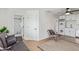 A cozy living room with a modern sofa, stylish rug, full bathroom, and a convenient washer/dryer setup at 2033 E Janice Way, Phoenix, AZ 85022