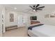 This main bedroom has a decorative ceiling fan, television, furniture, and access to the backyard pool area at 2033 E Janice Way, Phoenix, AZ 85022