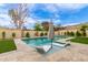 This backyard pool is surrounded by manicured artificial turf, a lounge area, and desert landscaping at 2033 E Janice Way, Phoenix, AZ 85022