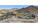 Aerial view of community with tennis courts, pool, and clubhouse set against a mountain backdrop at 20797 W Rattler Rd, Buckeye, AZ 85396