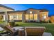 Inviting backyard with lounge chairs, seamless indoor-outdoor flow, and views of lush greenery at 20797 W Rattler Rd, Buckeye, AZ 85396