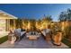 Backyard patio featuring modern outdoor seating, a stylish fire pit, and privacy landscaping for a relaxing retreat at 20797 W Rattler Rd, Buckeye, AZ 85396